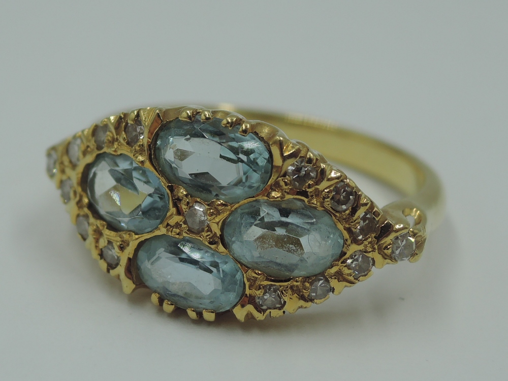 An aqua marine dress ring having four oval stones in a lozenge shaped panel with diamond chip - Image 3 of 4