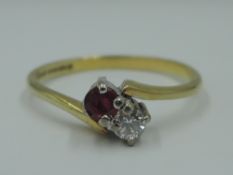 A ruby and diamond duo ring with crossover shoulders on an 18ct gold loop, size N & approx 2.3g