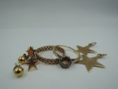A selection of yellow metal including star charms, earrings and a citrine style dress ring stamped