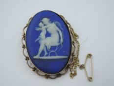 A Wedgwood jasperware brooch in a yellow metal decorative mount stamped 9ct
