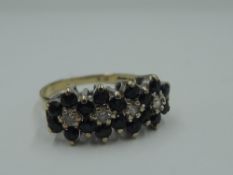 A sapphire and diamond quadruple cluster dress ring in a claw set basket mount on a 9ct gold loop,