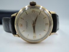A gent's 1960's 9ct gold wrist watch by J W Benson having Arabic and baton numeral dial and