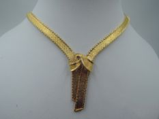 An 18ct gold collarette necklace of knotted plaited form with concealed clasp, approx 61.5g