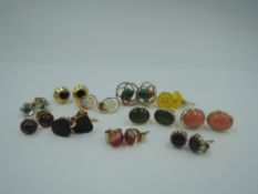 Eleven pairs of yellow metal stud earrings of various forms including, coral, opal, etc, approx 13.