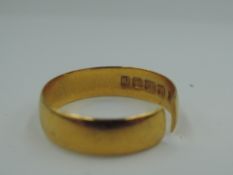 A 22ct gold wedding band (split), approx 2.7g