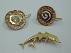 A pair of yellow metal Artisan style spiral disc loop earrings bearing worn marks, test as gold, and