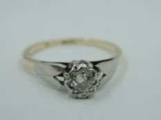 A diamond solitaire dress ring, approx 0.128ct in an illusionary setting to raised shoulders on a