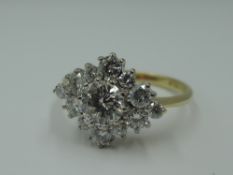 A diamond cluster dress ring having a central diamond, approx 0.60ct within a surround of 12