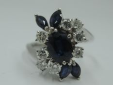 A lady's dress ring having a central sapphire, approx 0.75ct surrounded by four marquise cut