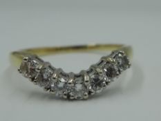 A lady's shaped half eternity ring having seven diamonds, total approx 0.35ct in a curved claw set