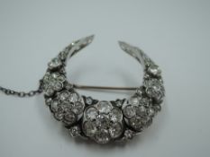 A Victorian diamond cluster crescent brooch with a total of approx 6ct of old cut diamonds in five