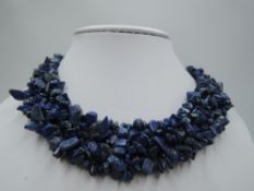 A woven multi strand rough cut lapis lazuli collarette necklace