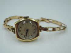 An 18ct gold vintage wrist watch having an Arabic numeral dial in an 18ct gold case on a yellow