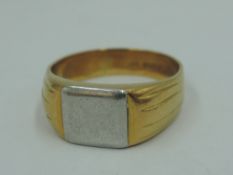 A gent's white and yellow metal signet ring stamped 18ct having a plain cartouche, size T & approx