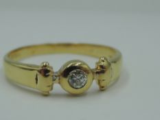 A diamond solitaire dress ring in a collared mount to shaped shoulders on an 18ct gold loop, size