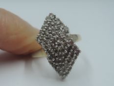 A diamond chip dress ring of stylised bow form, total approx 1ct, (1 stone missing) in a raised pave