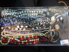 A selection of vintage and later costume jewellery including strings of beads, Rotary watch, stick