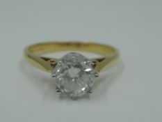 A diamond solitaire dress ring, approx 1ct in an eight claw coronet mount to knife blade shoulders
