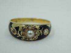 A Victorian 15ct gold mourning ring having seed pearl and black enamel decoration with hair panel to
