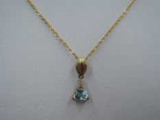 A 9ct gold pendant having cubic zirconia and turquoise paste stone on a 9ct gold chain, approx 2.7g