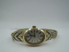 A lady's 9ct gold wrist watch by Rotary having a baton numeral dial to oval face in gold case on