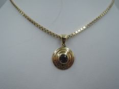 A yellow metal and amethyst circular pendant on a 9ct gold box chain, approx 18' & 12g