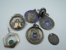 A small selection of silver including a hematite dress ring and four medalions including Leeds