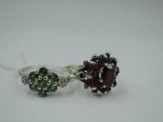A garnet cluster dress ring in a moulded decorative mount on a silver loop, size L & a peridot style