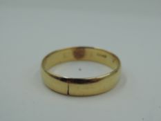 A yellow metal wedding band, marks worn, tests as 18ct gold, size R & approx 3g
