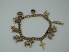 A yellow metal charm bracelet stamped 9ct having eleven yellow metal charms including pony,