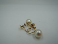 A pair of yellow metal screw back cultured pearl earrings stamped 9ct