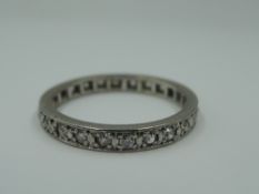 A diamond set full eternity ring having 24 pave set diamonds, total approx 0.75ct in a white metal