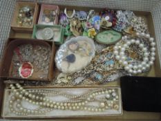 A selection of costume jewellery including brooches, earrings, chains etc