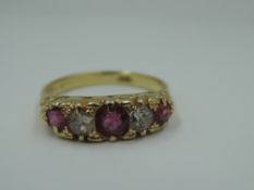 A ruby and diamond dress ring having three rubies interspersed by two old cut diamonds in a