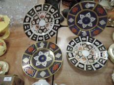 Two ceramic display plates by Royal Crown Derby in imari designs and a similar pair of Caverswall