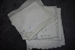 A vintage linen table cloth and napkins with cut work and embroidery.