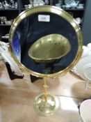 A double sided brass shaving mirror.