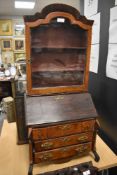 A 19th century specimen or apprentice piece in the form of a bureau bookcase, using a variety of