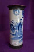 A Blue and white Chinese vase depicting three men and a building surrounded by foliage.