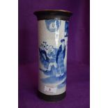 A Blue and white Chinese vase depicting three men and a building surrounded by foliage.