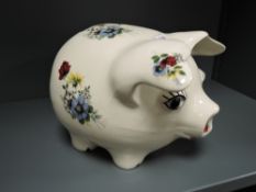 A large ceramic piggy bank having transfer print design