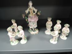 A collection of late 18th century cherubs or similar holding baskets of flowers, and similar lady in