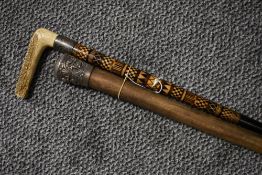 An antique silver topped Burmese walking cane and a similar horn handle walking stick