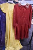 A 1940s full length yellow gown and a 1930s day dress.