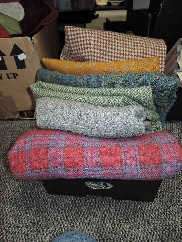 A box full of vintage ladies wool and wool blend skirts, predominantly around 1950s and 1960s.