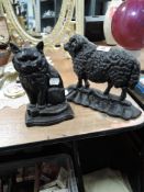 Two vintage cast iron door stops one in the form of a sheep and another as a cat