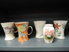 A collection of Moorcroft including small vase with pink floral design and blanks including mugs and