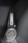 A metal cased barometer having a metal tear drop design case