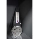 A metal cased barometer having a metal tear drop design case