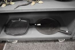 Two cast iron skillets/Griddles.